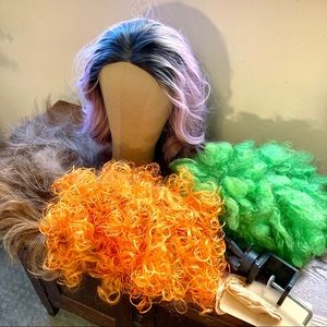 Lot of four wigs and a wig stand
